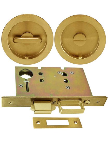 Premium Pocket-Door Mortise Lock Set with Round Pulls in Aged Brass.
